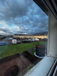 a view from a window of a parking lot at Caol Mountain View in Caol +10 photos