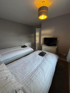 a bedroom with two beds and a television in it at Caol Mountain View in Caol