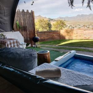 a swimming pool in the backyard of a tent at The Jolly Joint Clarens in Clarens