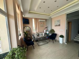 a living room with a couch and chairs at HOTEL BRIZ - Free Parking in Burgas