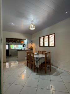 a kitchen and dining room with a table and chairs at Lazer Hostel in Barreirinhas