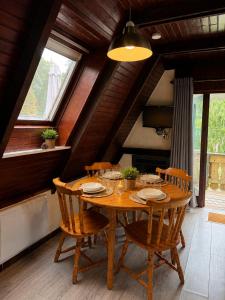 a wooden table with chairs in a room at Chalet in Le Tholy