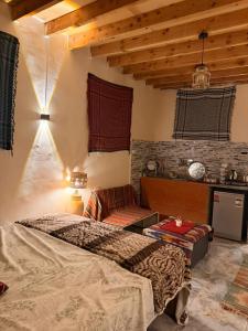 a bedroom with a bed and a couch at Omar Cozy in Dahab