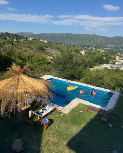 a swimming pool with two people swimming in it at Casa Mirador del Lago in Villa Parque Siquiman