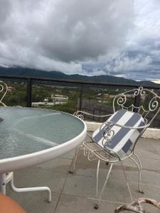 a table and a chair on a balcony with a view at Casa Mirador del Lago in Villa Parque Siquiman