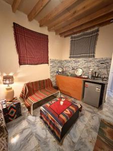 a living room with a couch and a table at Omar Cozy in Dahab +5 photos