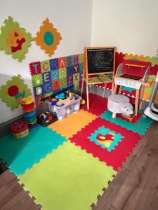 a childs room with a classroom with a chalkboard at En prairie in Malmerspach