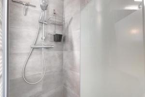a bathroom with a shower with a shower head at Les Gemeaux 2 - 6 personnes in Villard-de-Lans +23 photos