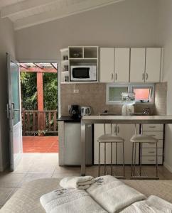 a kitchen with a counter and stools in a room at Carilo Princess in Carilo
