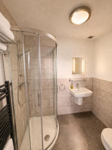 a bathroom with a shower and a sink at The Lyncroft in Newquay +33 photos