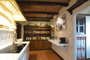 a kitchen with wooden cabinets and a counter top at Insolites à Chimay - Les roulottes à Rièzes in Chimay