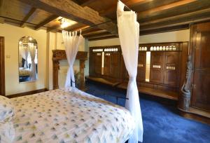 a bedroom with a bed with curtains and wooden cabinets at Insolites à Chimay - Les roulottes à Rièzes in Chimay +55 photos