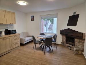 a living room with a table and chairs and a fireplace at Le Nid d'Étoiles in Schiltigheim +6 photos