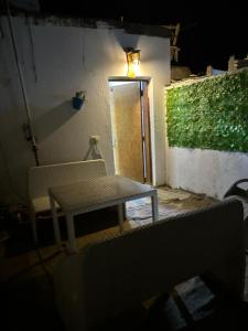 a table and a bench in front of a door at Omar Cozy in Dahab