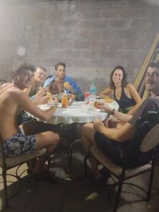 a group of people sitting around a table eating at SWELL house, EL TUNCO in El Sunzal