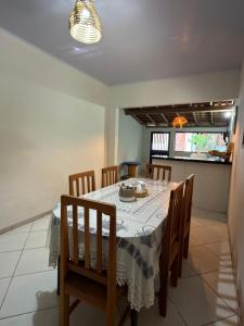 a dining room with a table and chairs and a window at Lazer Hostel in Barreirinhas +59 photos