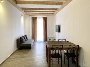 a living room with a table and chairs and a couch at Homenfun Vila Badalona in Badalona