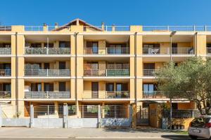 an apartment building with balconies on a street at Casa Claudia in Elmas
