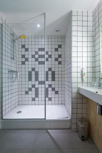 a bathroom with a shower with a glass door at Ibis Styles Paris Place d'Italie - Butte Aux Cailles in Paris