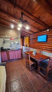 a dining room with a wooden table and chairs at Aypa Pacha Nono in Nono
