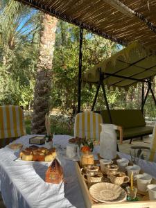 a table with food and plates of food on it at Dar hania in Tozeur