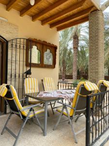 a patio with a table and chairs on a porch at Dar hania in Tozeur