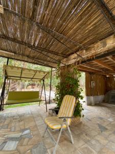 a chair sitting on a patio under a roof at Dar hania in Tozeur