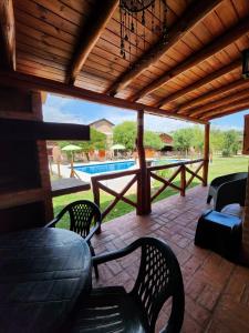a patio with a table and chairs and a pool at Aypa Pacha Nono in Nono