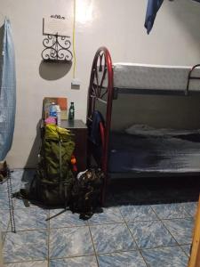 a room with a bunk bed and a backpack on the floor at SWELL house, EL TUNCO in El Sunzal