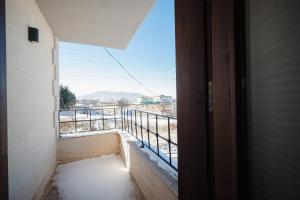 an open door with a view of a balcony at Castle Stone House in Uçhisar