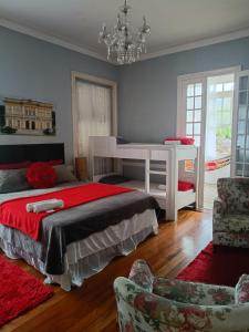 a bedroom with a bed and a desk and chairs at Hotel Cidade Imperial in Petrópolis