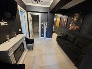 a living room with a couch and a table at JohnResidence in Valea Lupului