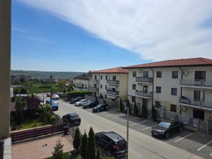 a parking lot with cars parked in a parking lot at JohnResidence in Valea Lupului