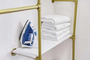 a towel rack with a stack of towels at 8040 Harding Apts in Miami Beach +38 photos