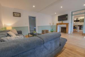 a living room with a couch and a fireplace at Chez nenette in Prugny