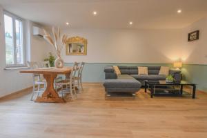 a living room with a table and a couch at Chez nenette in Prugny