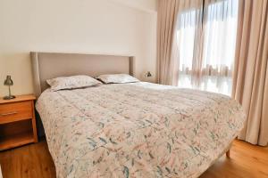 a bedroom with a bed and a window at Steps from the Shopping del Sol! in Asunción