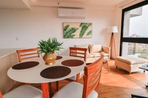 a living room with a white table and chairs at Large Apartment Just Steps from Shopping del Sol in Asunción