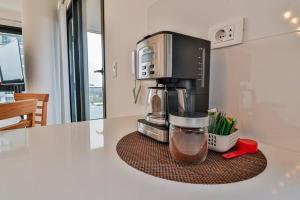 a coffee maker sitting on a counter in a kitchen at Large Apartment Just Steps from Shopping del Sol in Asunción
