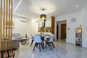a living room and dining room with a table and chairs at Silentium Apartment in Donji Prozor