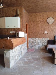 a kitchen with a counter and a stone wall at -DO- Gradac in Šavnik
