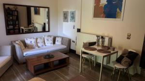 a living room with a couch and a table at Elis Studio Luxury Apartment in Ierapetra