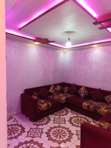 a living room with a couch and purple lights at Casa Yessef Akchour in Akchour