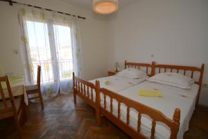 a bedroom with a large wooden bed with white sheets at Penzion Sovulj SKALLA CZ in Omiš +34 photos