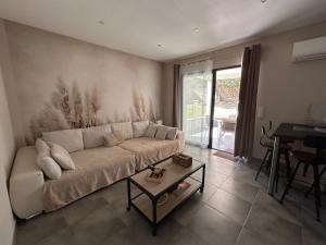 a living room with a couch and a table at Résidence Alba in Bonifacio