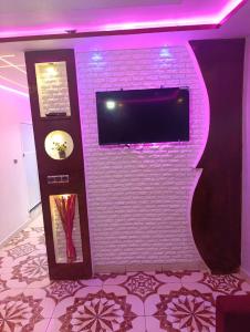 a white brick wall with a flat screen tv on it at Casa Yessef Akchour in Akchour