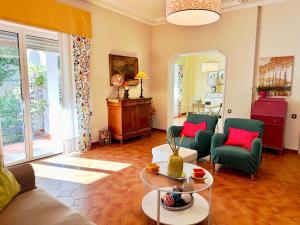 a living room with a couch and chairs and a table at Villa Dolce Vita in San Vincenzo