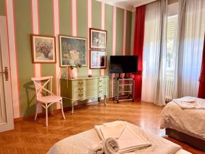 a living room with a dresser and a television at Villa Dolce Vita in San Vincenzo