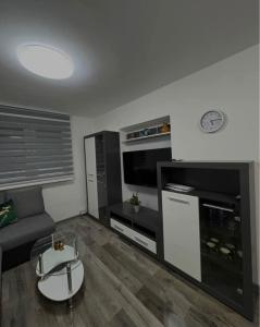 a living room with a couch and a tv at Jadranka in Vinkovci