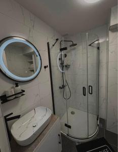 a bathroom with a shower and a toilet and a mirror at Jadranka in Vinkovci